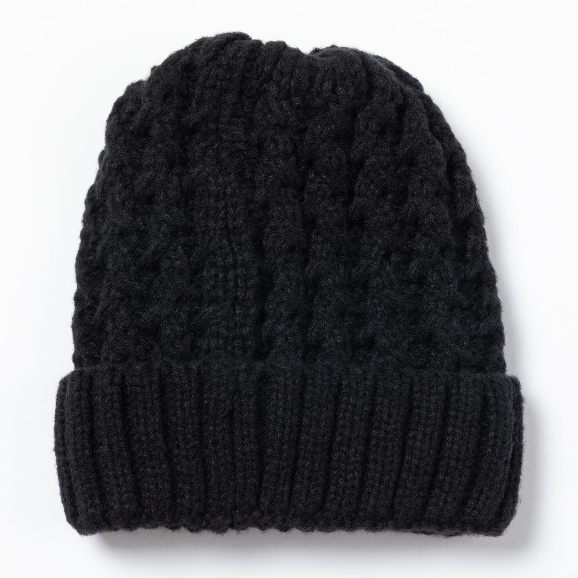 Black cable knit beanie on a white background.