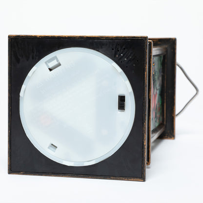 The bottom of a christmas cardinal theme lantern, showing where the on/off switch is.