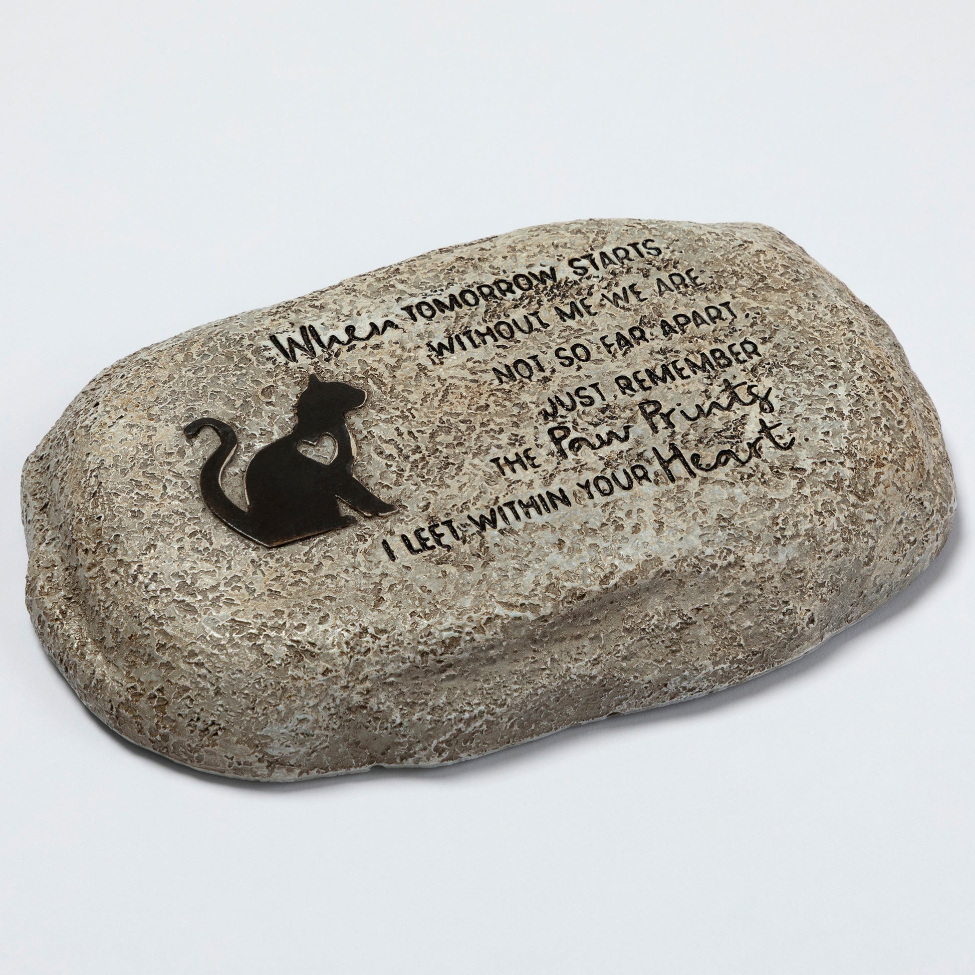 Decorative stone with a black cat silhouette and engraved text on a light gray background