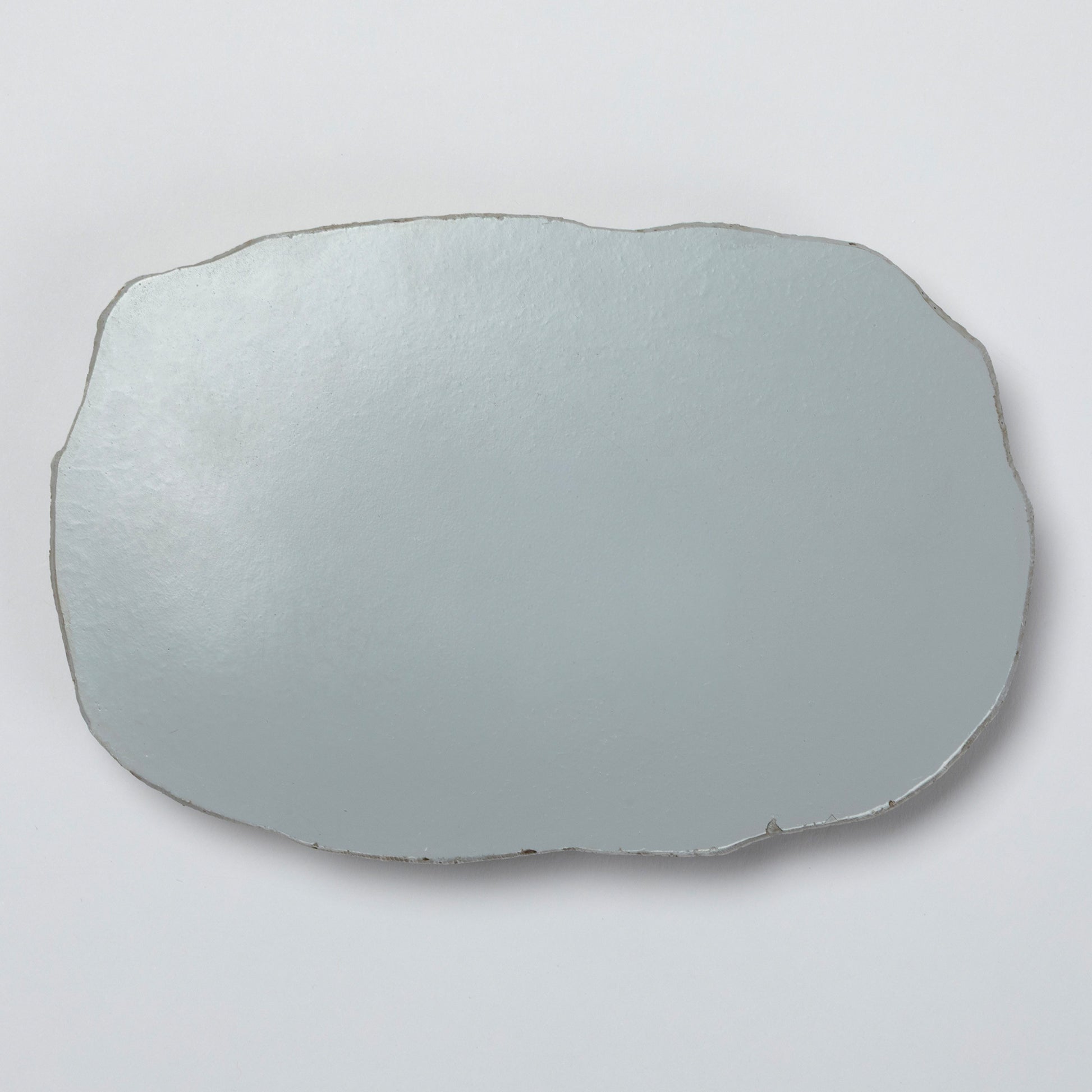 The back of the polyresin garden stone on a light gray background