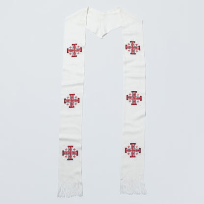 An off-white woolen liturgical stole with embroidered red and blue crosses, laid flat against a light gray background.