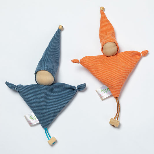 Two triangular fabric gnomes with pointed hats on a clean white background. One gnome is made of blue corduroy fabric with a wooden face and hat tip, and the other is made of orange corduroy fabric with a wooden face and hat tip.
