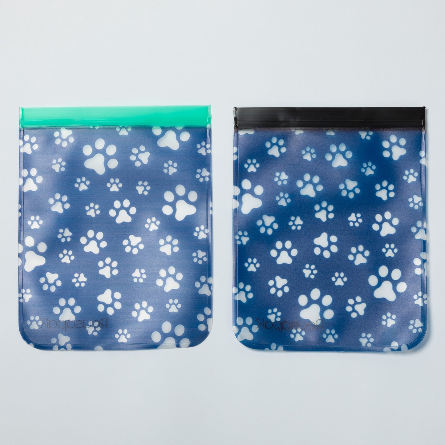 Two blue bags with white paw prints on a light gray background