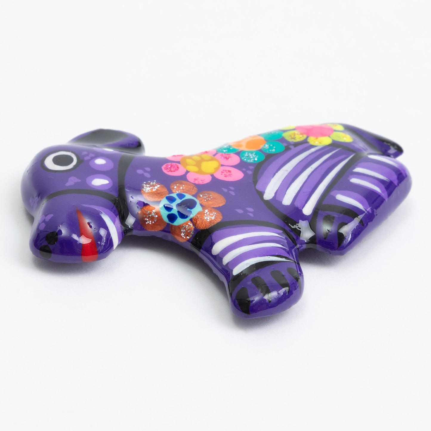 Purple hand painted ceramic dog magnet against a white background.