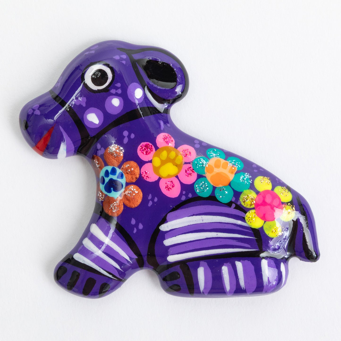 Purple hand painted ceramic dog magnet against a white background.
