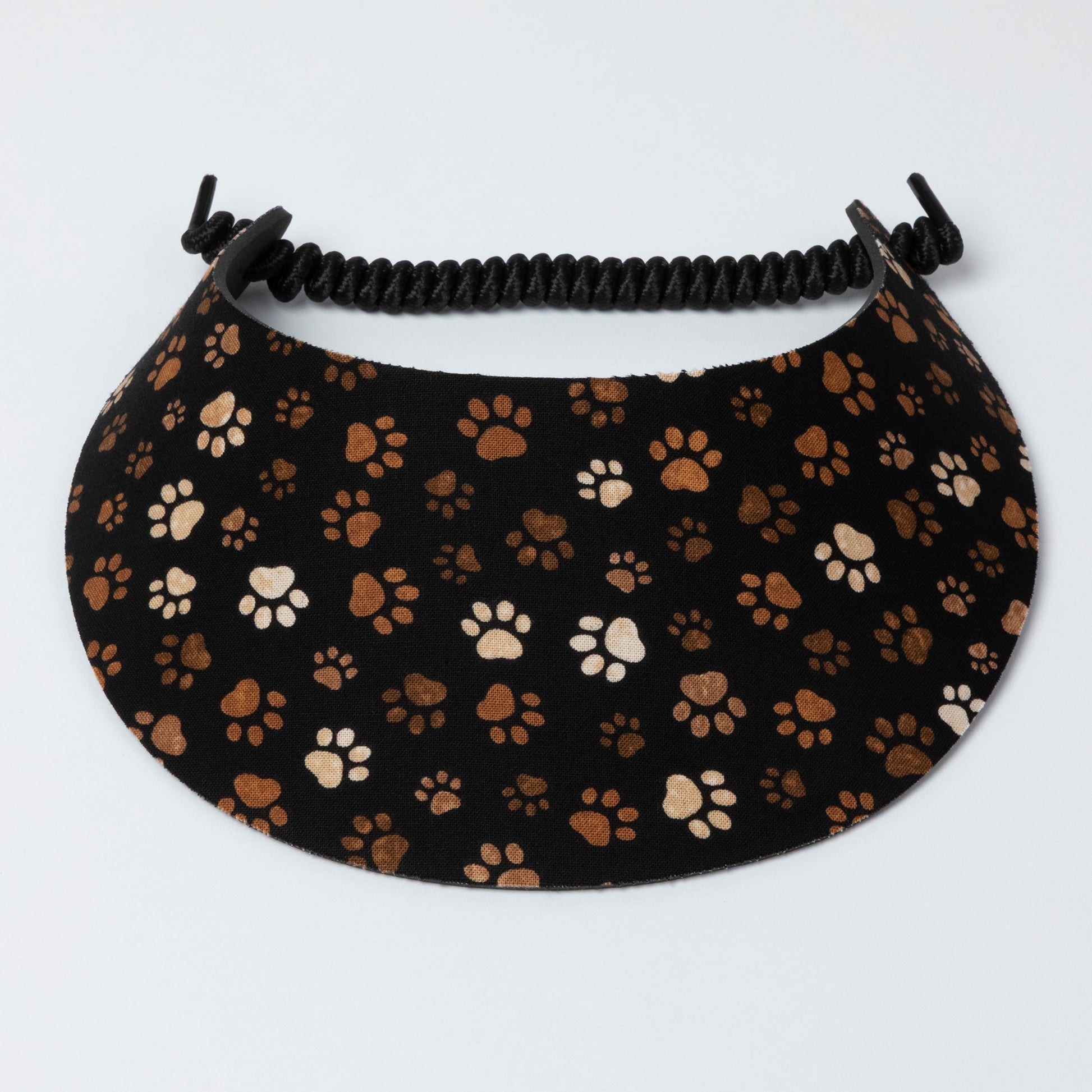 Visor with paw print pattern on a black background