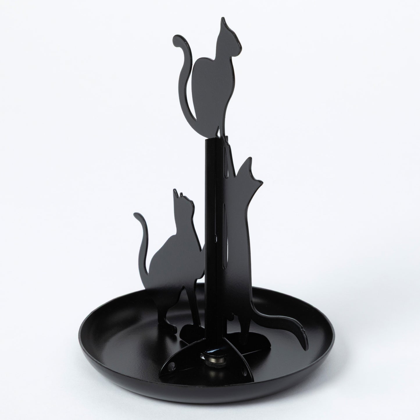 A black metal cat-shaped kitchen towel rack with three cat silhouettes mounted on a central pole above a round tray, shown on a light gray background.