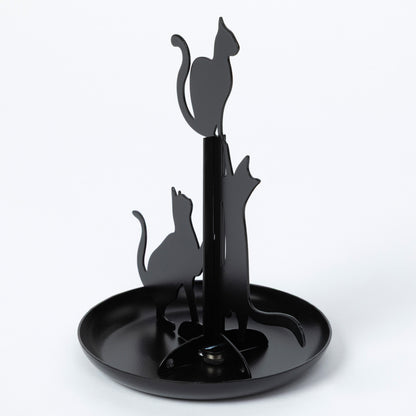 A black metal cat-shaped kitchen towel rack with three cat silhouettes mounted on a central pole above a round tray, shown on a light gray background.
