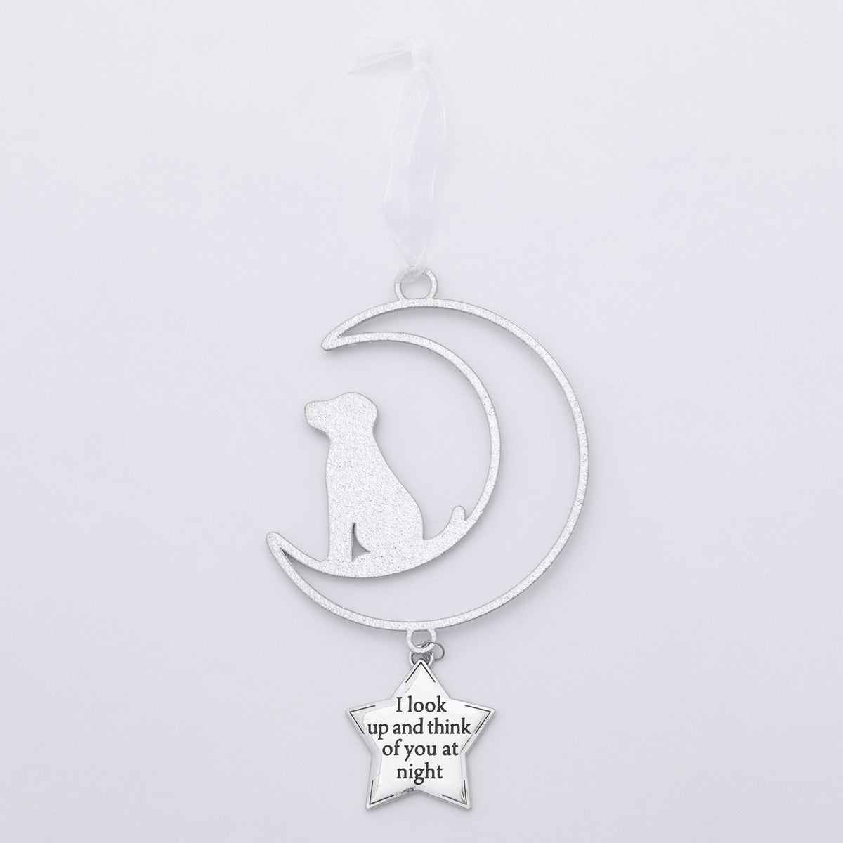 A silver metal pet memorial ornament featuring a crescent moon with a sitting dog silhouette and a dangling star charm that reads 'I look up and think of you at night', shown on a plain light gray background.