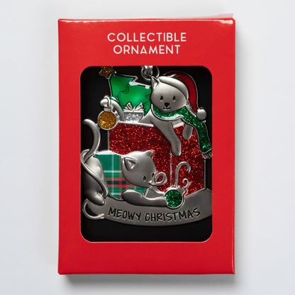 A collectible ornament in its red retail packaging, featuring two silver-toned cats with green and red holiday accents and the text 'MEOWY CHRISTMAS' on a black window card.