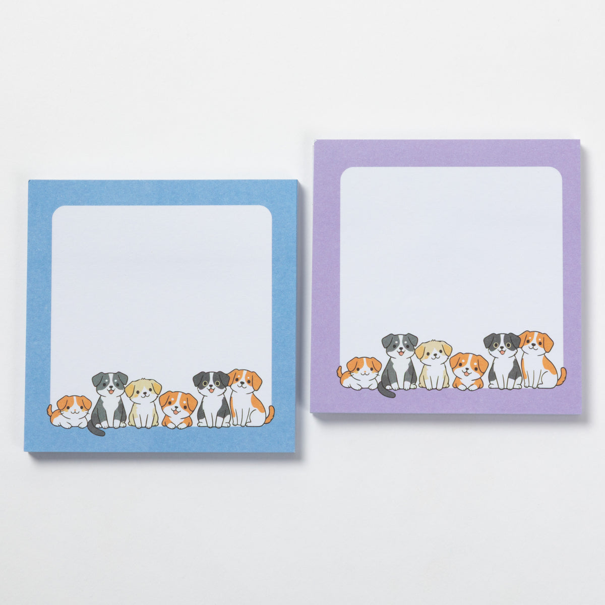 Two square sticky note pads with rounded corners on a white background. The left pad has a light blue border and the right pad has a lavender purple border, both featuring a row of cute illustrated dogs along the bottom edge.
