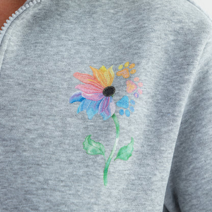 Close-up of a heather gray sweatshirt featuring a colorful flower design on the chest.