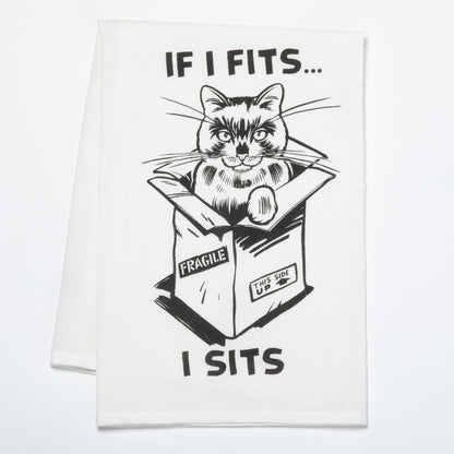 Cat in a box with humorous text on a white dish towel
