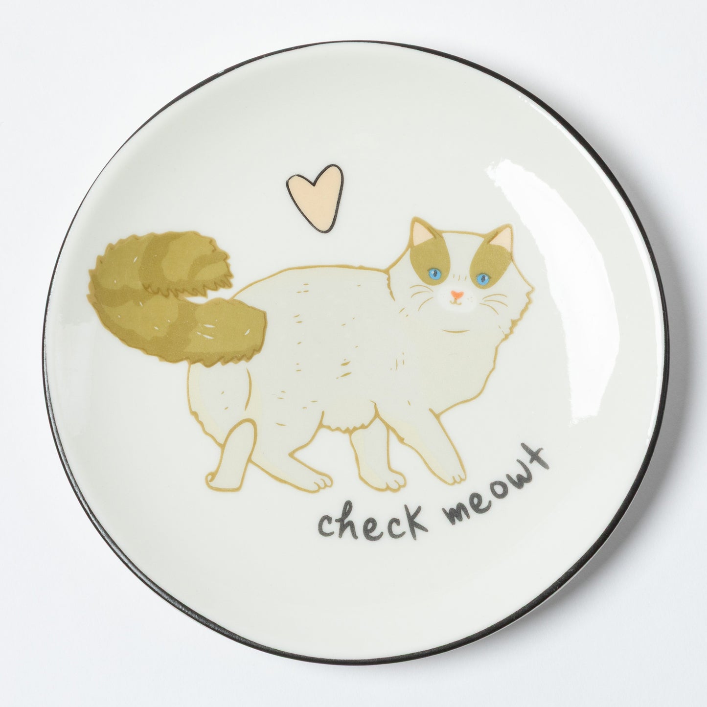 A round white ceramic plate with a black rim, featuring a hand-drawn illustration of a white cat with green-tinted eyes and a gold-tinted tail, a small beige heart above, and the text 'check meowt' below.