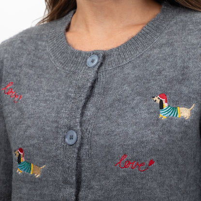 Close-up of a gray knit cardigan sweater with embroidered dachshunds wearing striped sweaters and red 'love' script text on the chest.