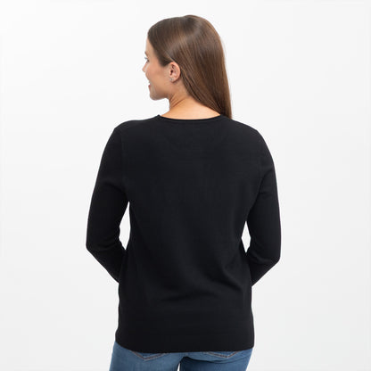 A woman viewed from the back wearing a black long-sleeve crewneck sweater and blue jeans against a plain white background.