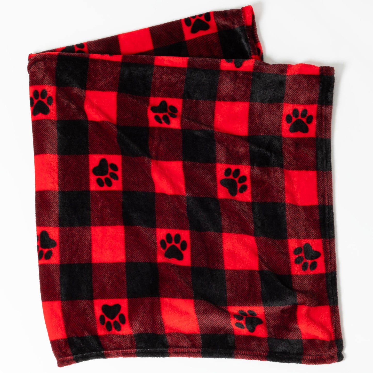 Folded red and black checkered blanket with paw prints on a white background