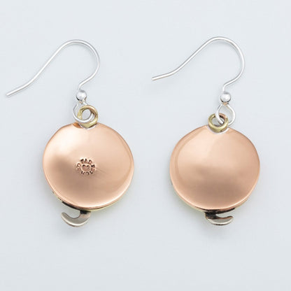 Back of copper circular earrings on a light gray background