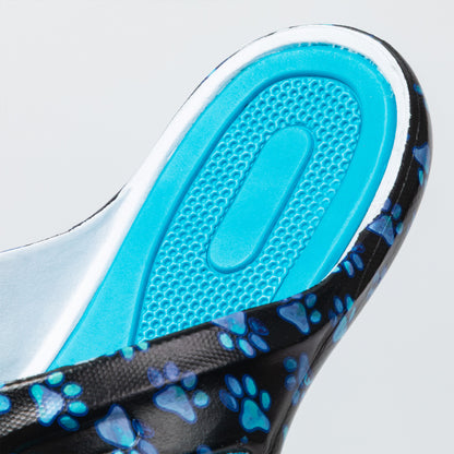 Close-up of a flip flop with a blue textured insole on a light gray background