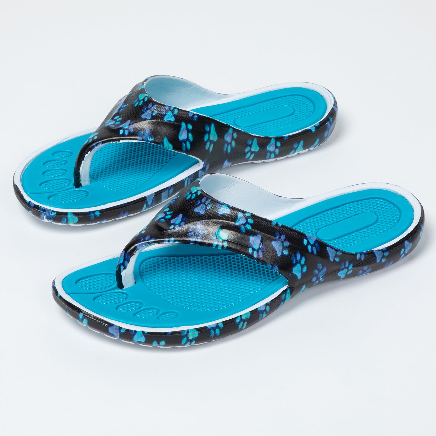 Pair of blue sandals with black paw print pattern on a light gray background