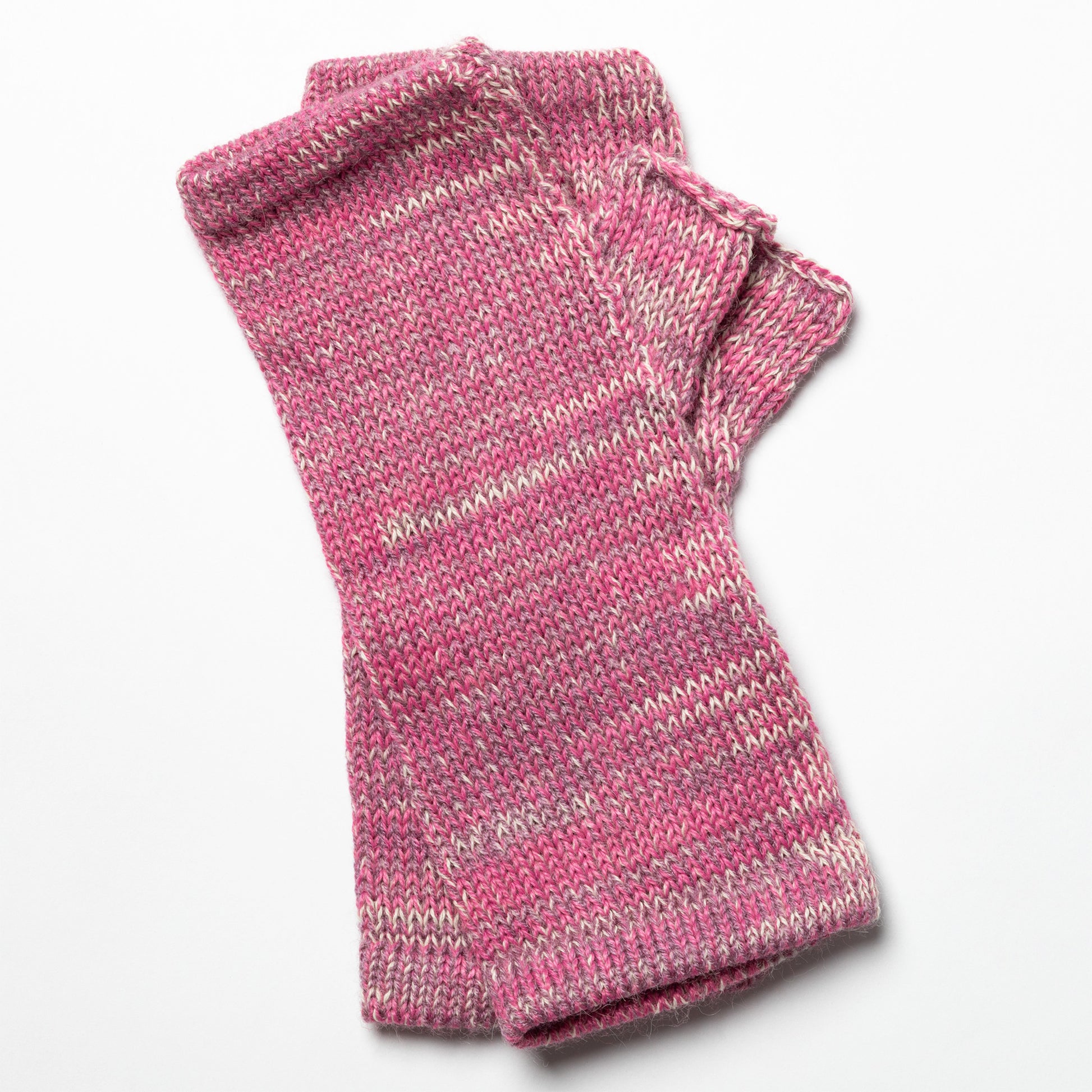Pink knitted fingerless gloves on a white background