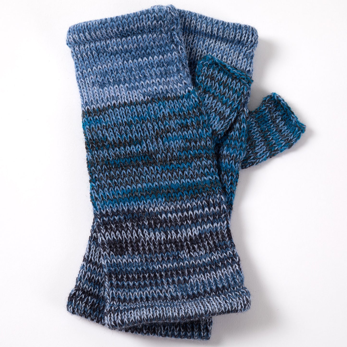 a pair of alpaca fingerless mittens in shades of blue made from alpaca wool on a white background