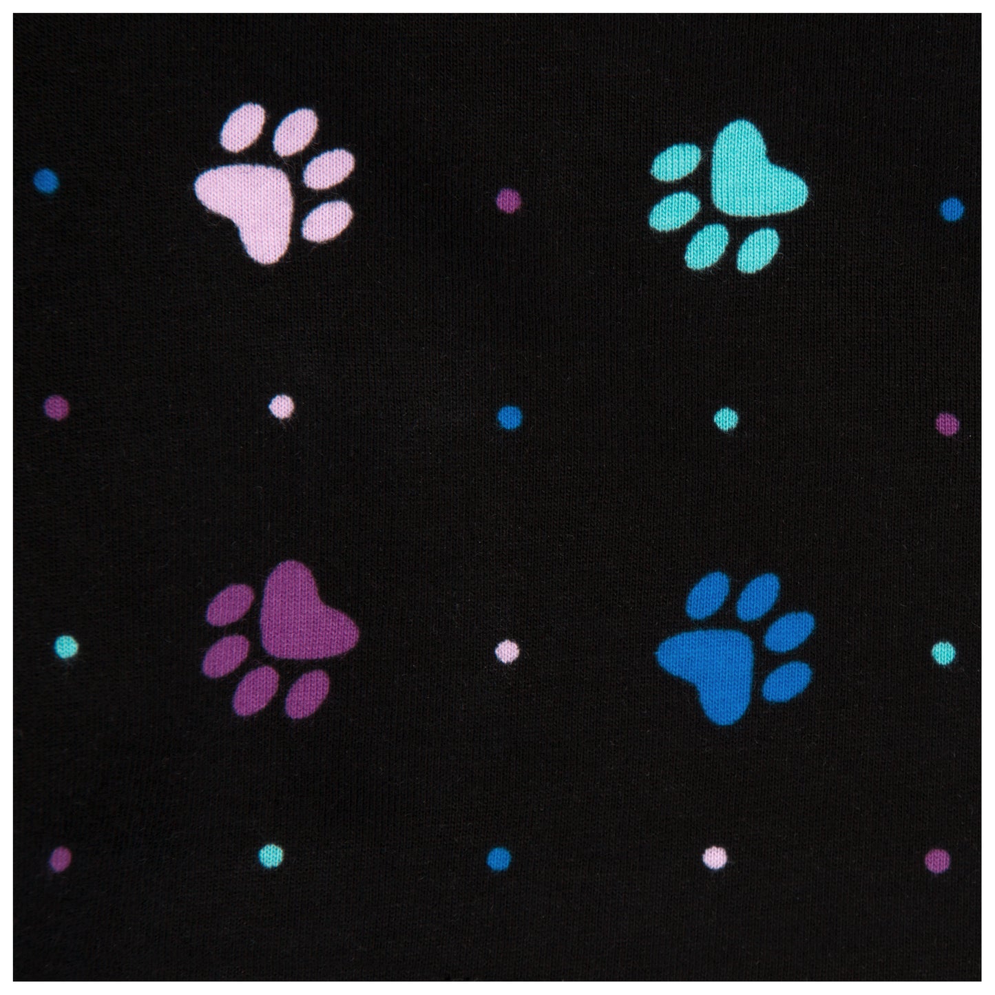 close up image of Black fabric of shorts with colorful paw prints and polka dots