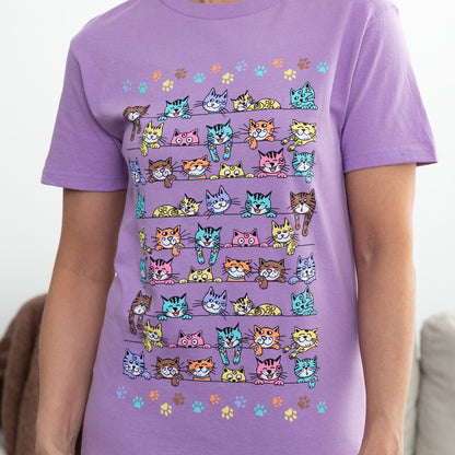Purple t-shirt with colorful cat pattern worn by a person