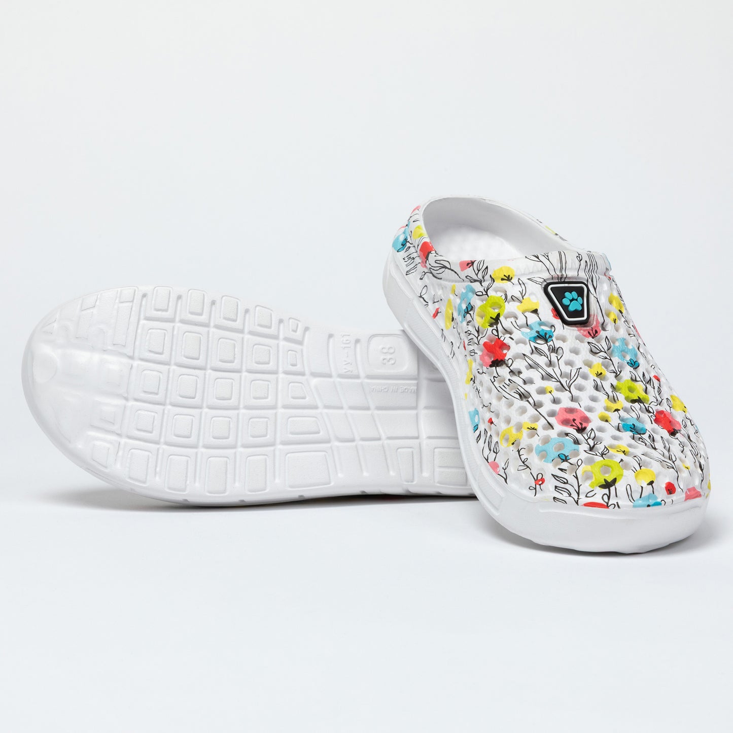 White slip-on shoe with floral design on a light gray background