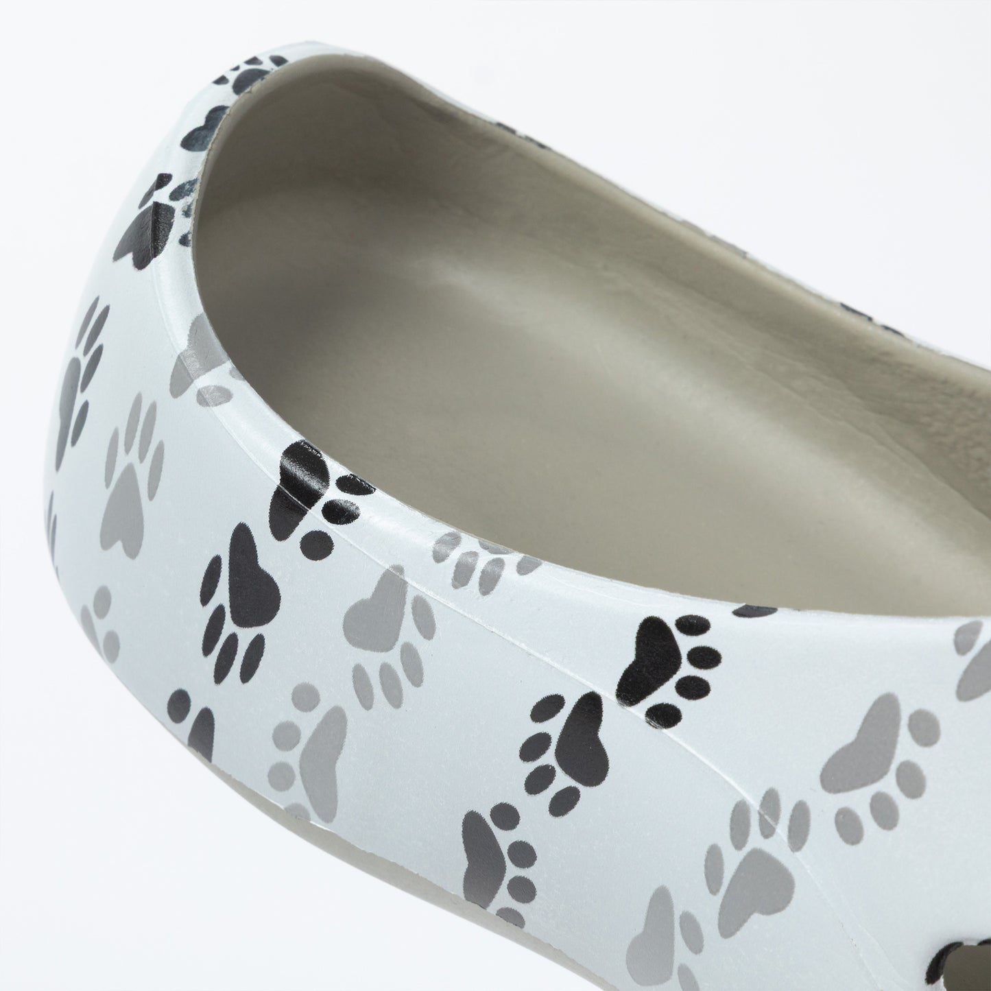 White shoe with black and gray paw print pattern on a white background
