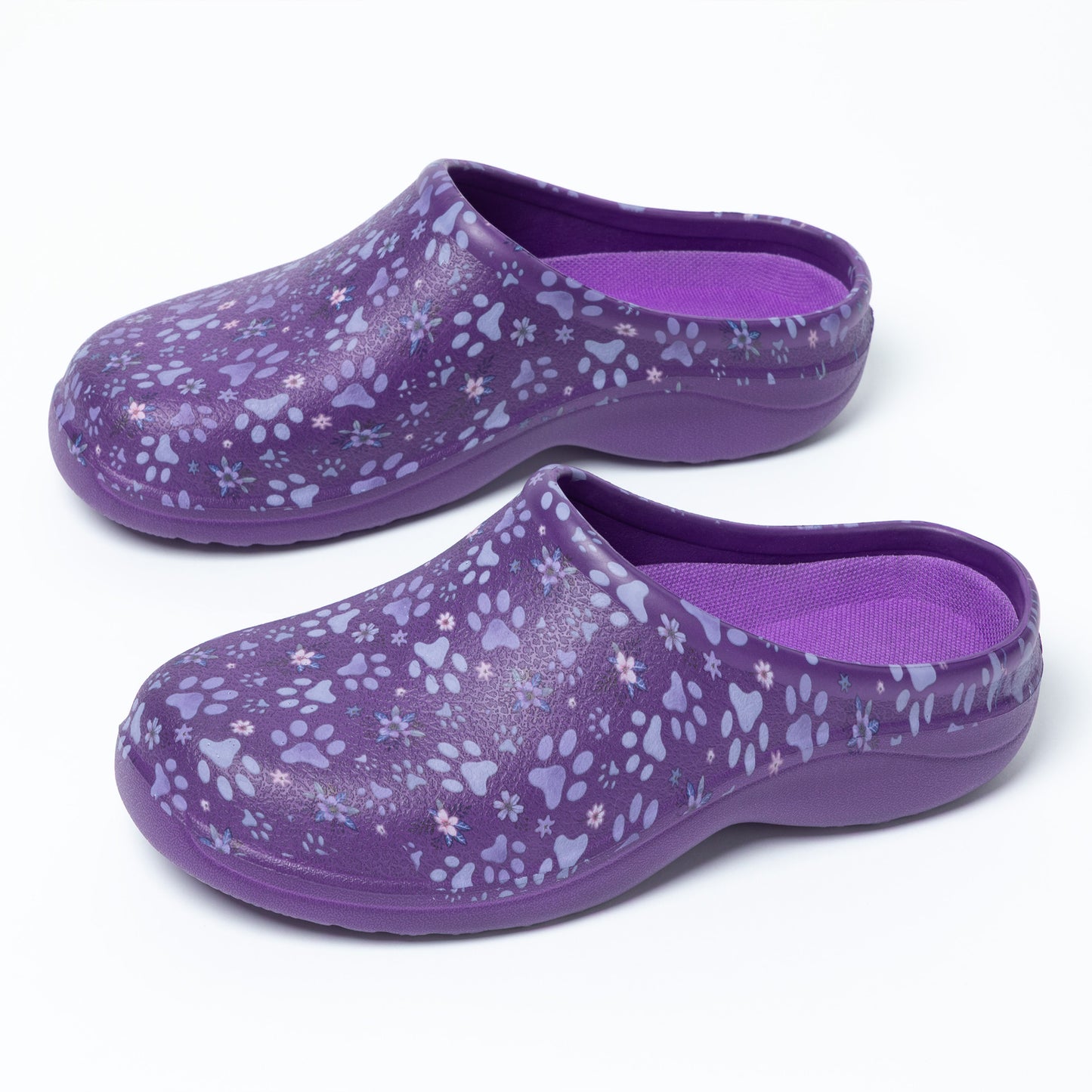 Pair of purple clogs with floral pattern on a white background