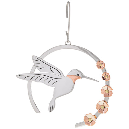 Decorative ornament with a hummingbird and floral design on a white background