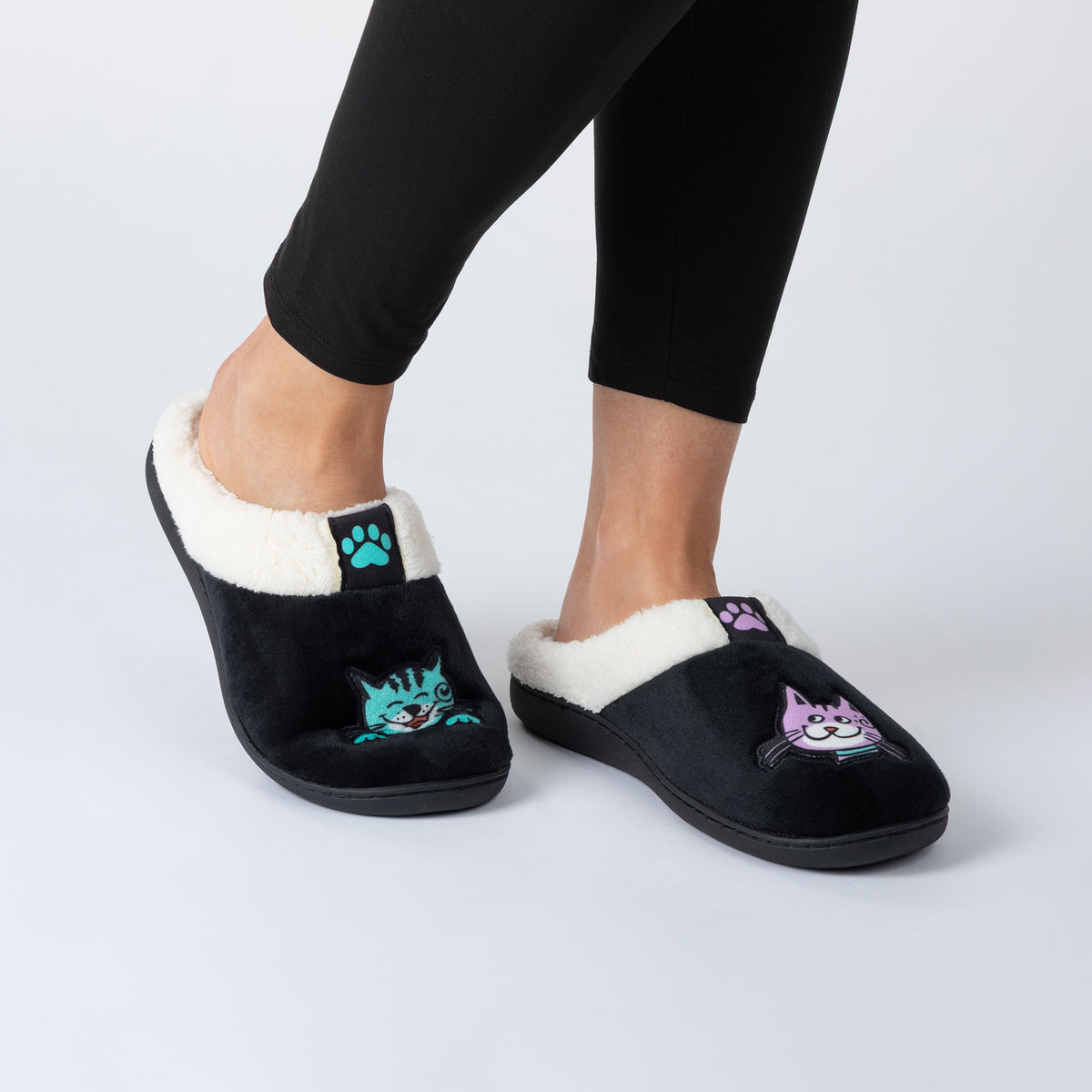 Black slippers with cat prints on top on model