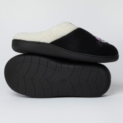 A pair of black slip-on slippers with a white sherpa lining, with one slipper stacked on top of the other to show the textured black sole.