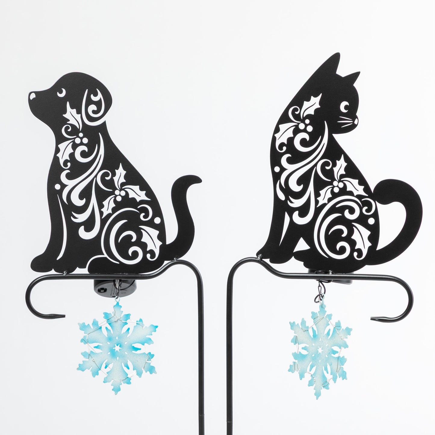 Decorative metal cat and dog silhouettes with floral patterns on a white background.
