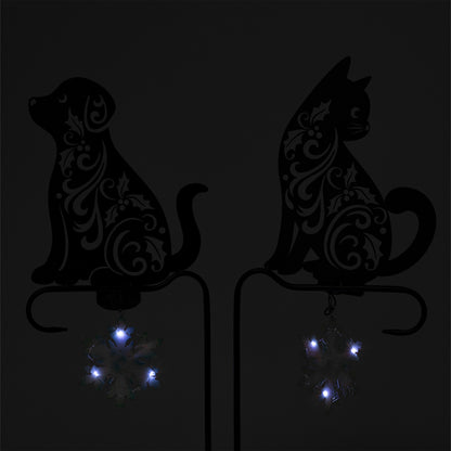 Decorative silhouettes of a dog and a cat with LED lights on a dark background