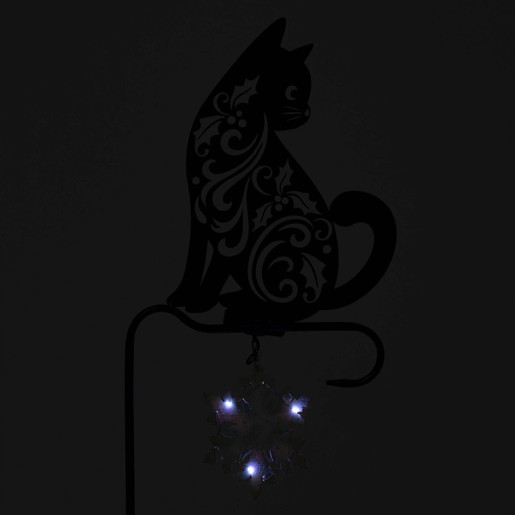 Decorative black cat silhouette with blue lights on a dark background