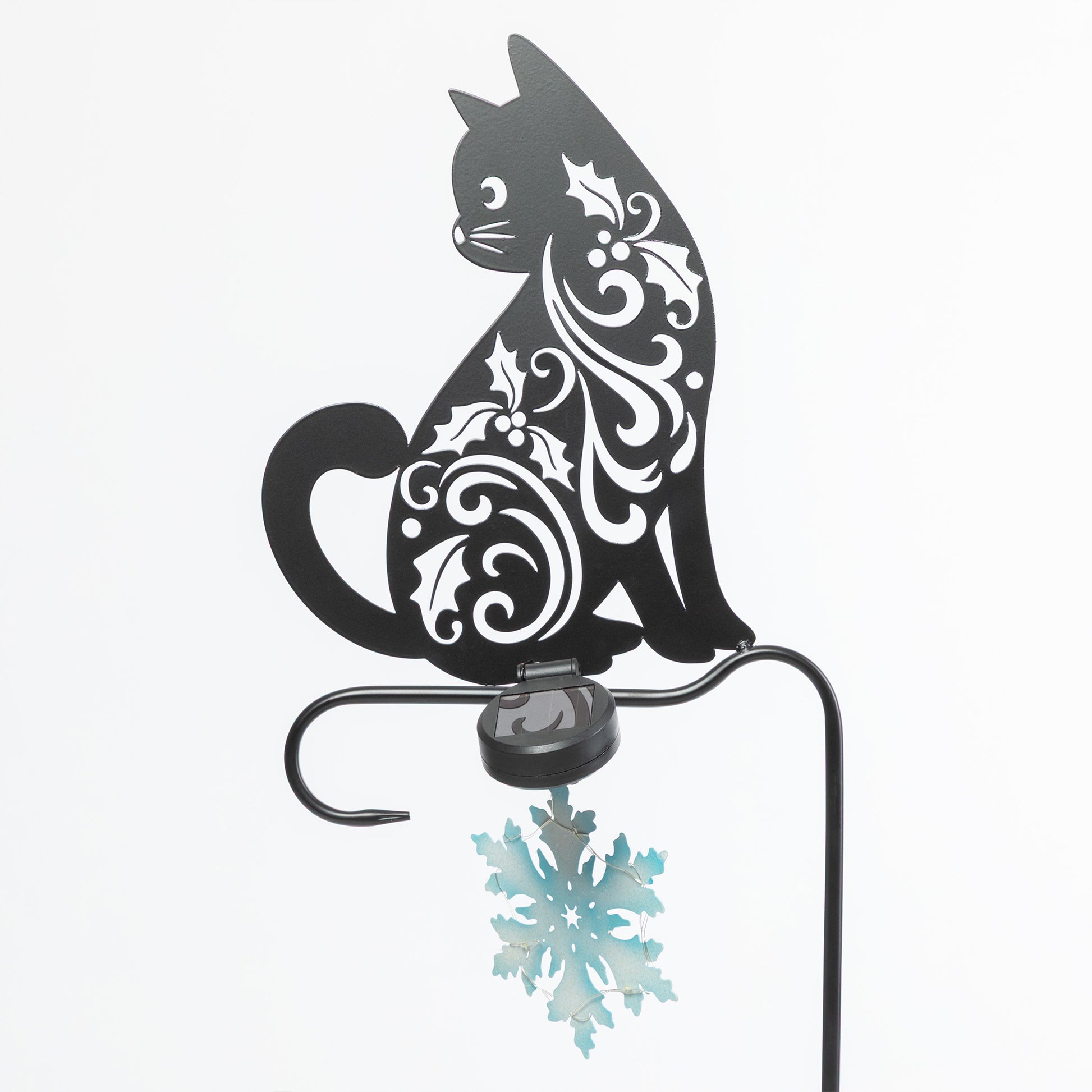 Decorative metal cat with snowflake design on a white background