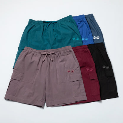 Five pairs of shorts in different colors with embroidered paw prints on a white background