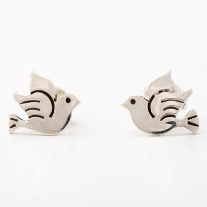 Pair of silver peace dove-shaped earrings on a white background