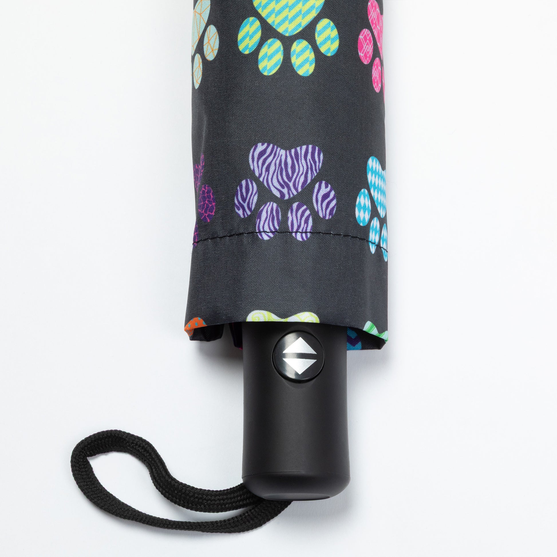 Collapsible umbrella with colorful paw print pattern on a white background