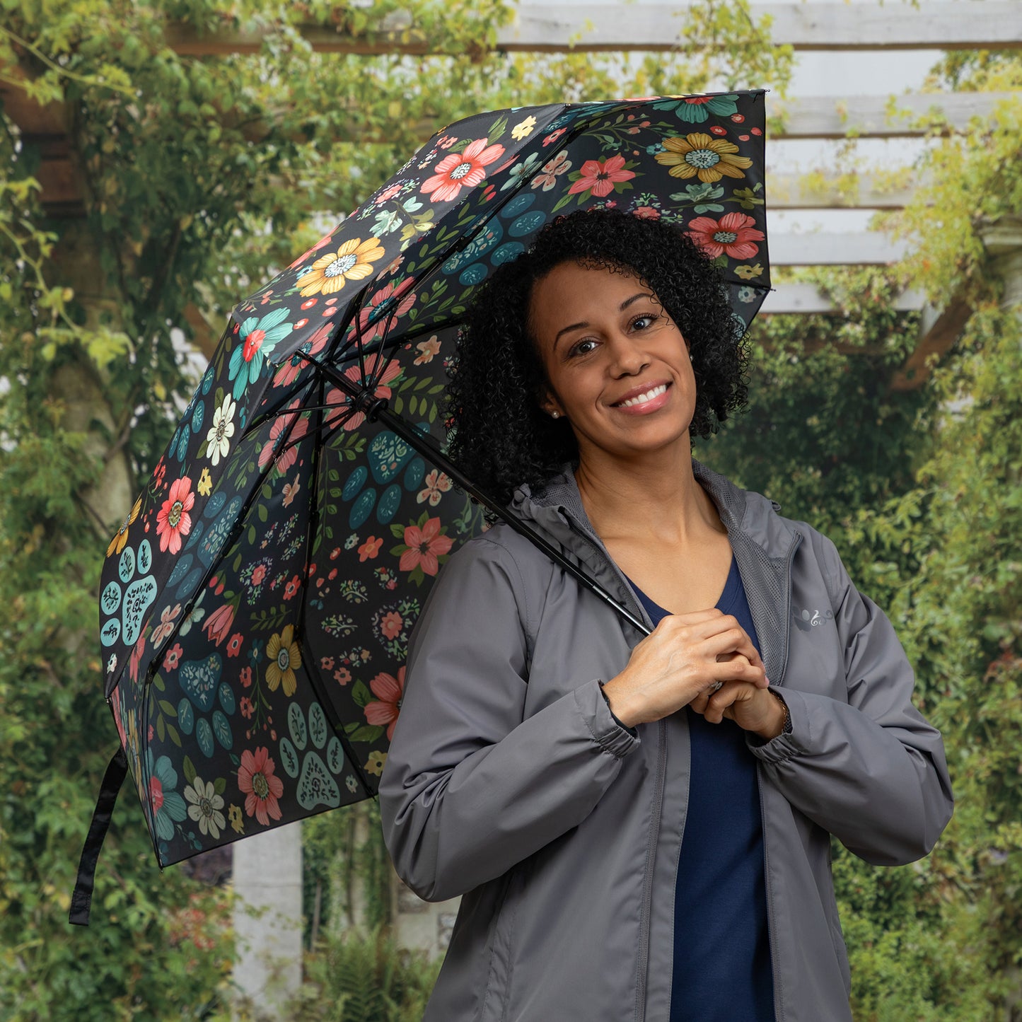 Woman holding a floral-patterned umbrella outdoors