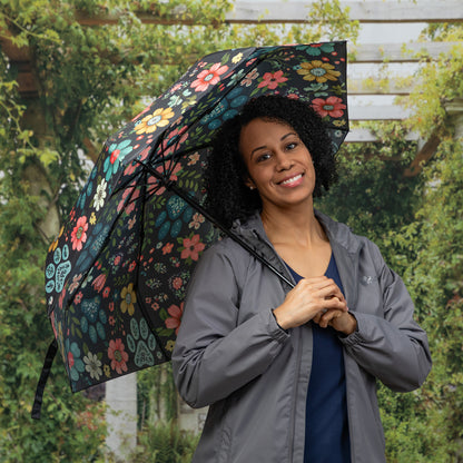 Woman holding a floral-patterned umbrella outdoors