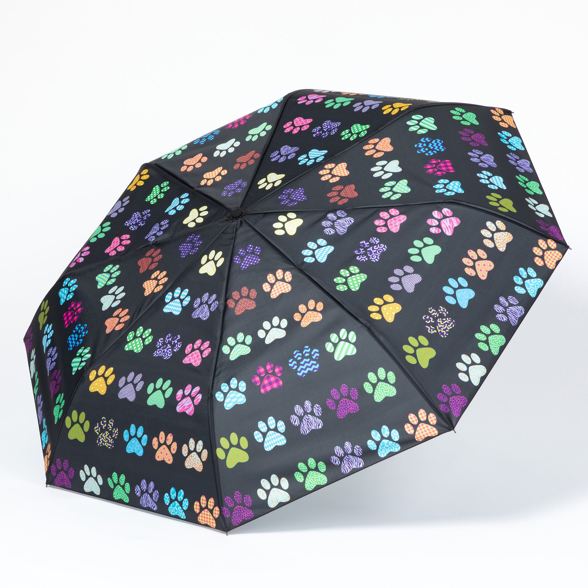 Black umbrella with colorful paw print pattern on a white background