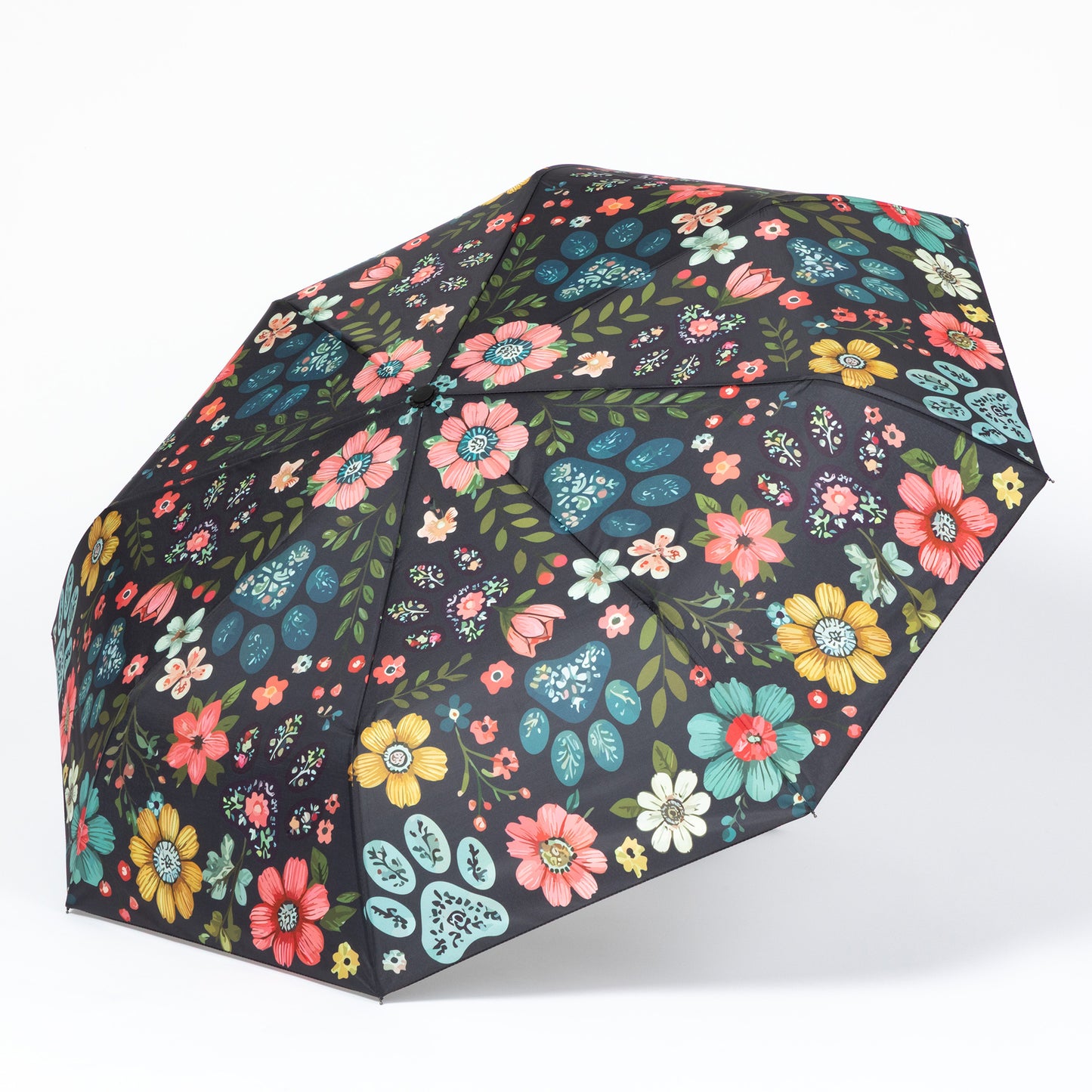 Floral-patterned paw print umbrella on a white background