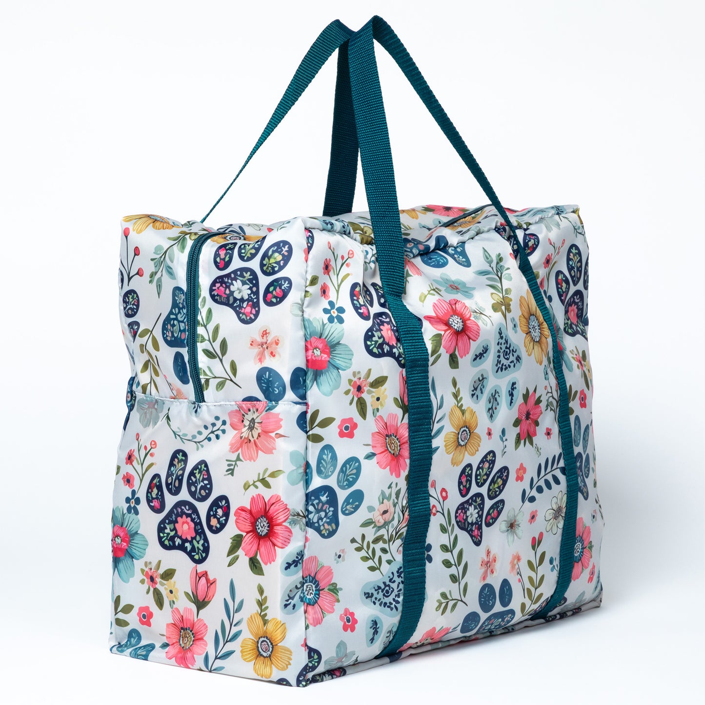 Floral patterned tote bag with blue straps on a white background