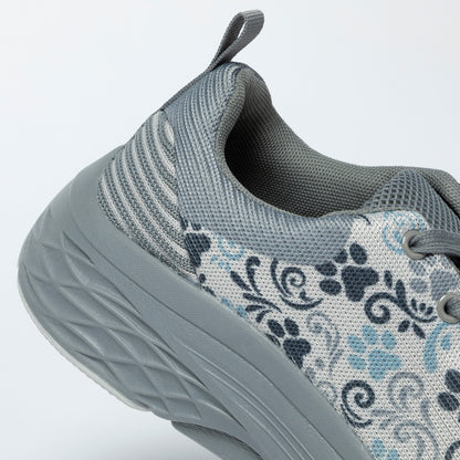 Gray sneaker with paw print pattern on a light gray background