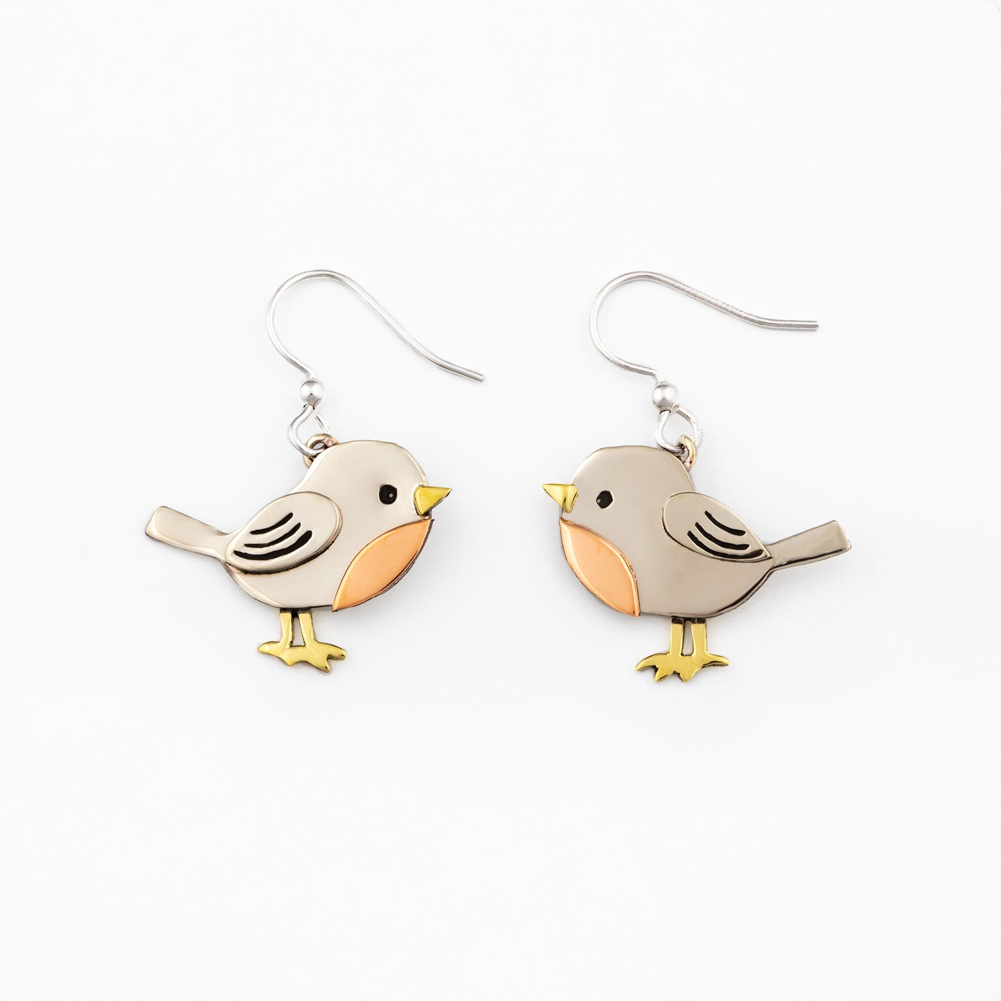 Bird-shaped silver earrings with brass and copper accents on a white background.