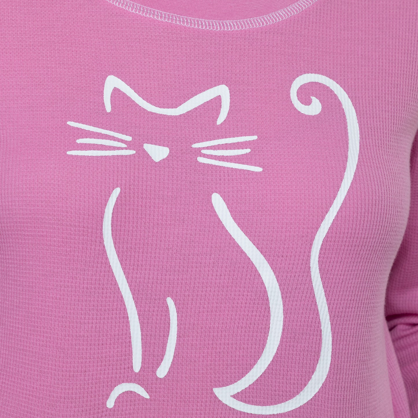Close up of a pink thermal long sleeve tee with a playful white cat outline design.