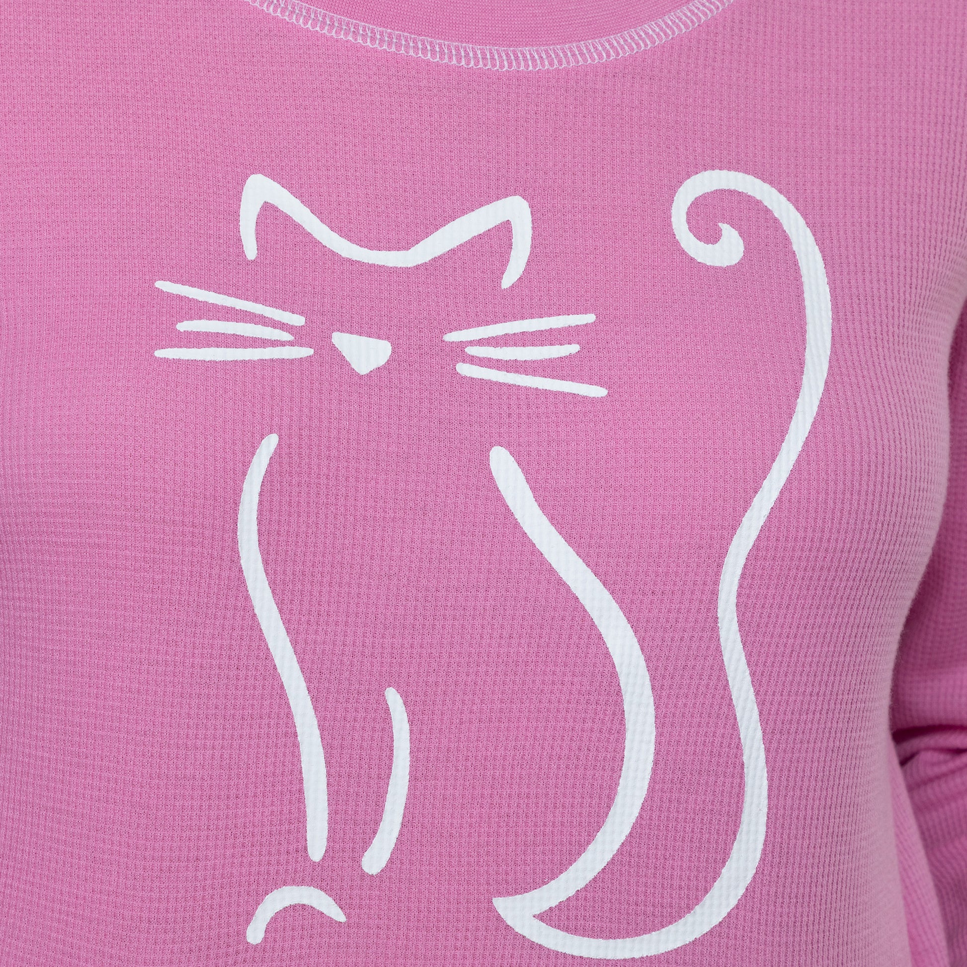 Close up of a pink thermal long sleeve tee with a playful white cat outline design.